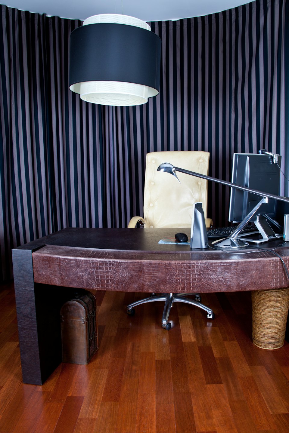 Luxurious home office with dark brown crocodile-embossed desk.